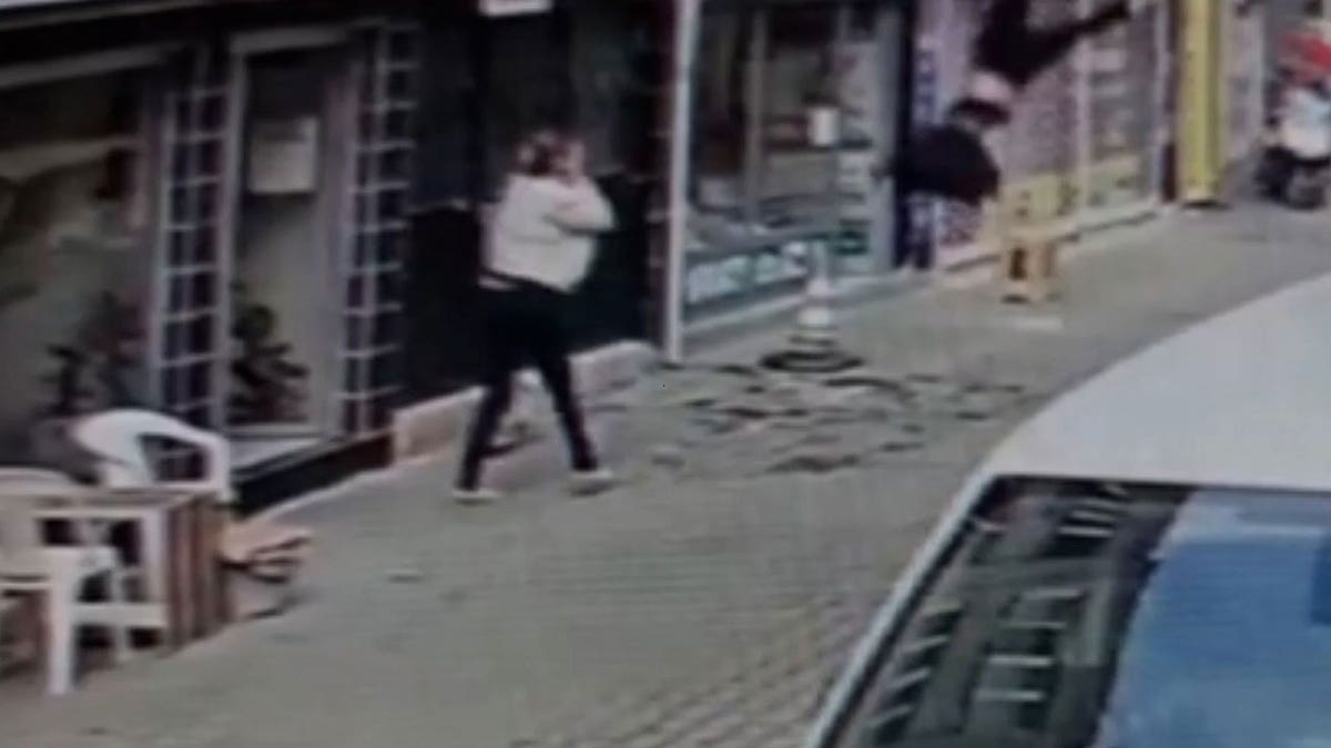 Melike Gun Kanavuzlar shown mid-air in a screenshot from a surveillance video