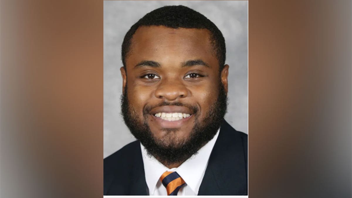 Mike Hollins Jr., a person injured during the shooting at the University of Virginia, wears an orange and black suit and tie.