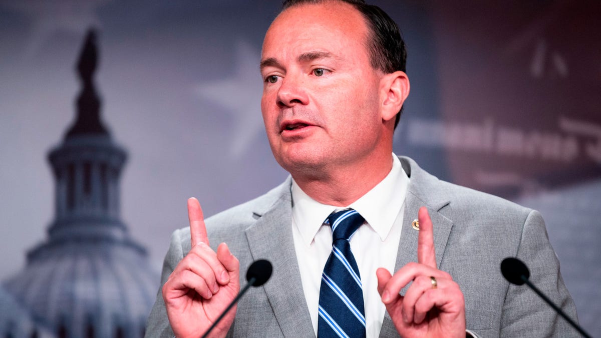 Sen. Mike Lee both hands pointing up in air, at microphone