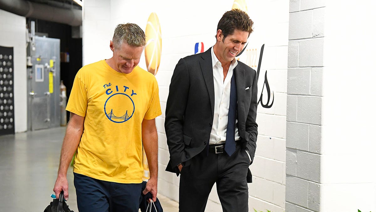 Steve Kerr and Bob Myers walk at the arena