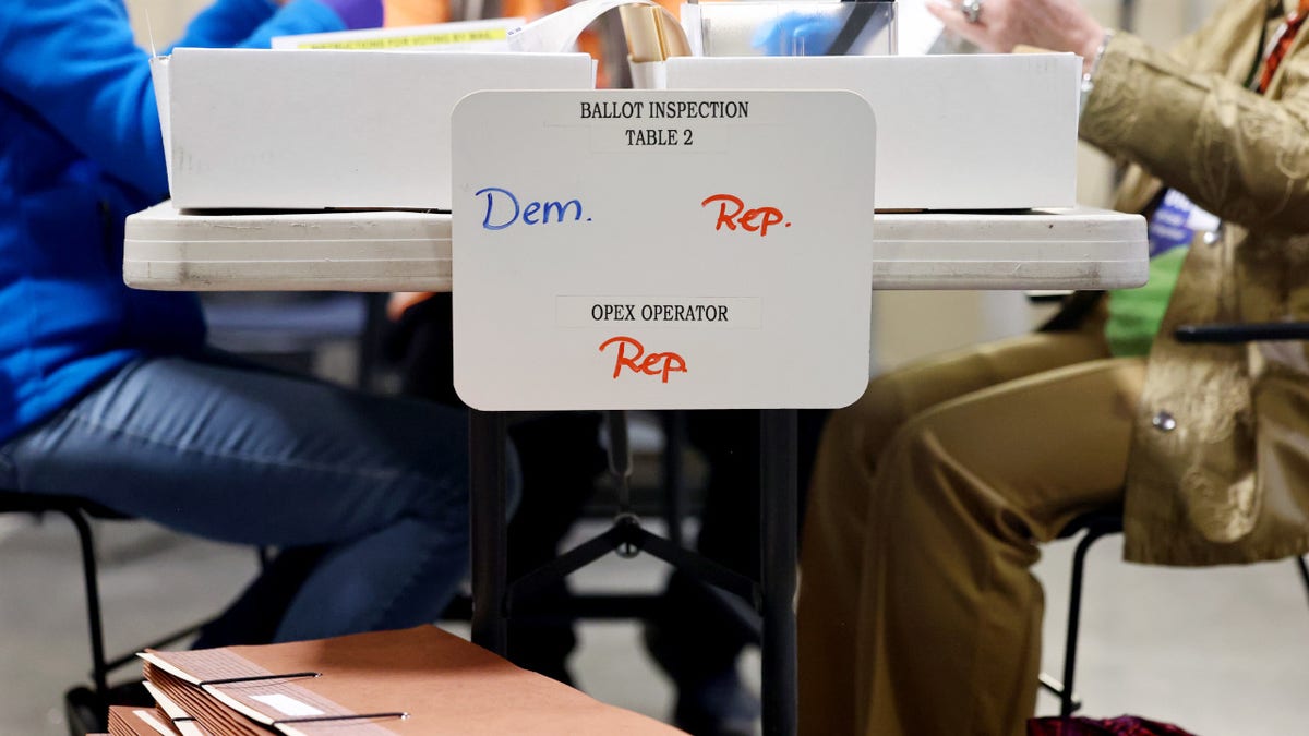 Nevada election officials process ballots at table