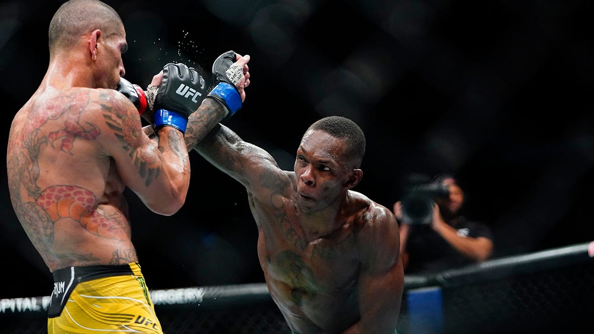 Israel Adesanya throws a hand