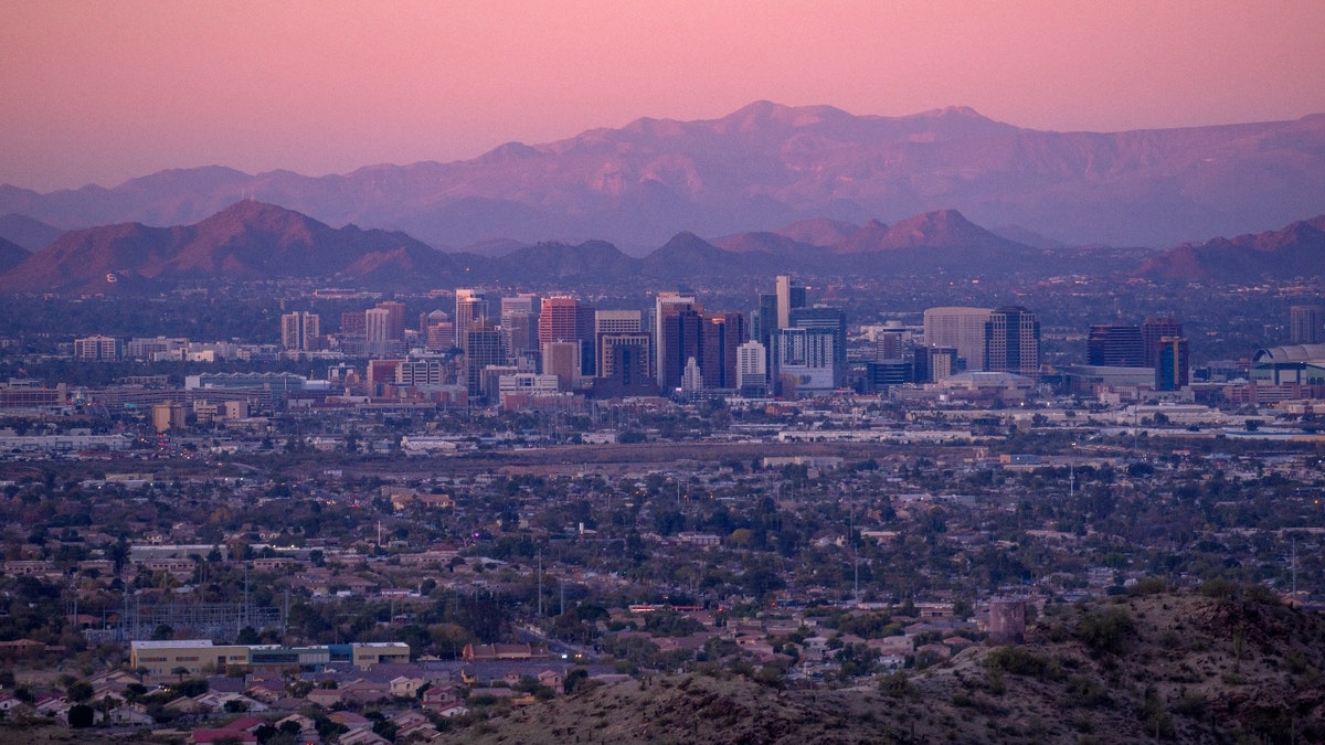 Phoenix, Arizona downtown skyline with interstate at sunset