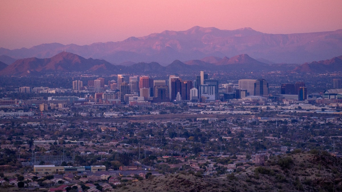 Phoenix, Arizona downtown skyline with interstate at sunset