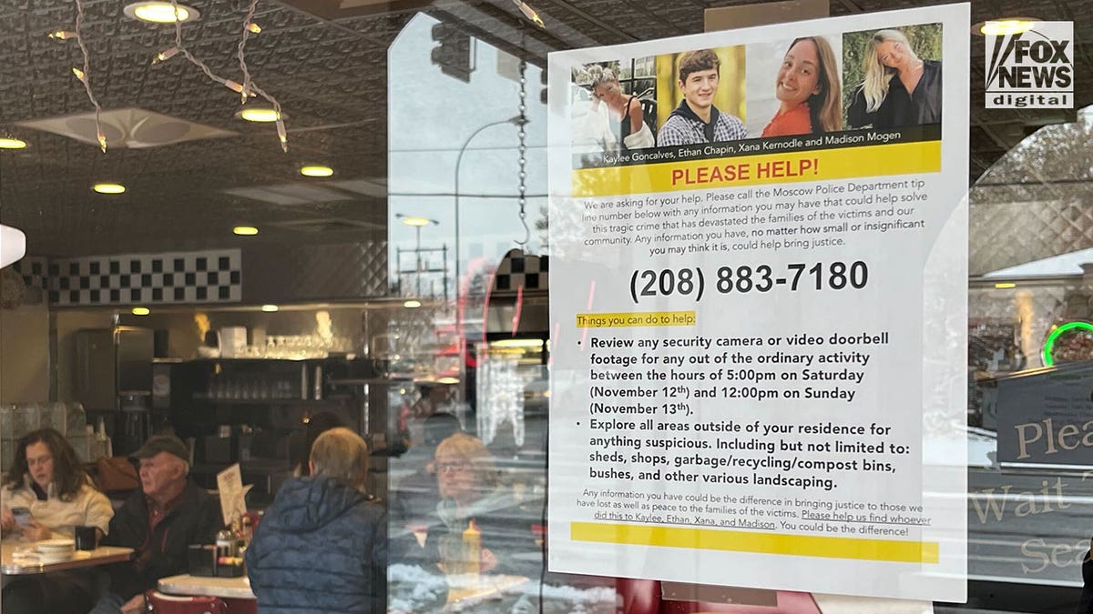 A paper sign is posed in the inside of a diner's front window