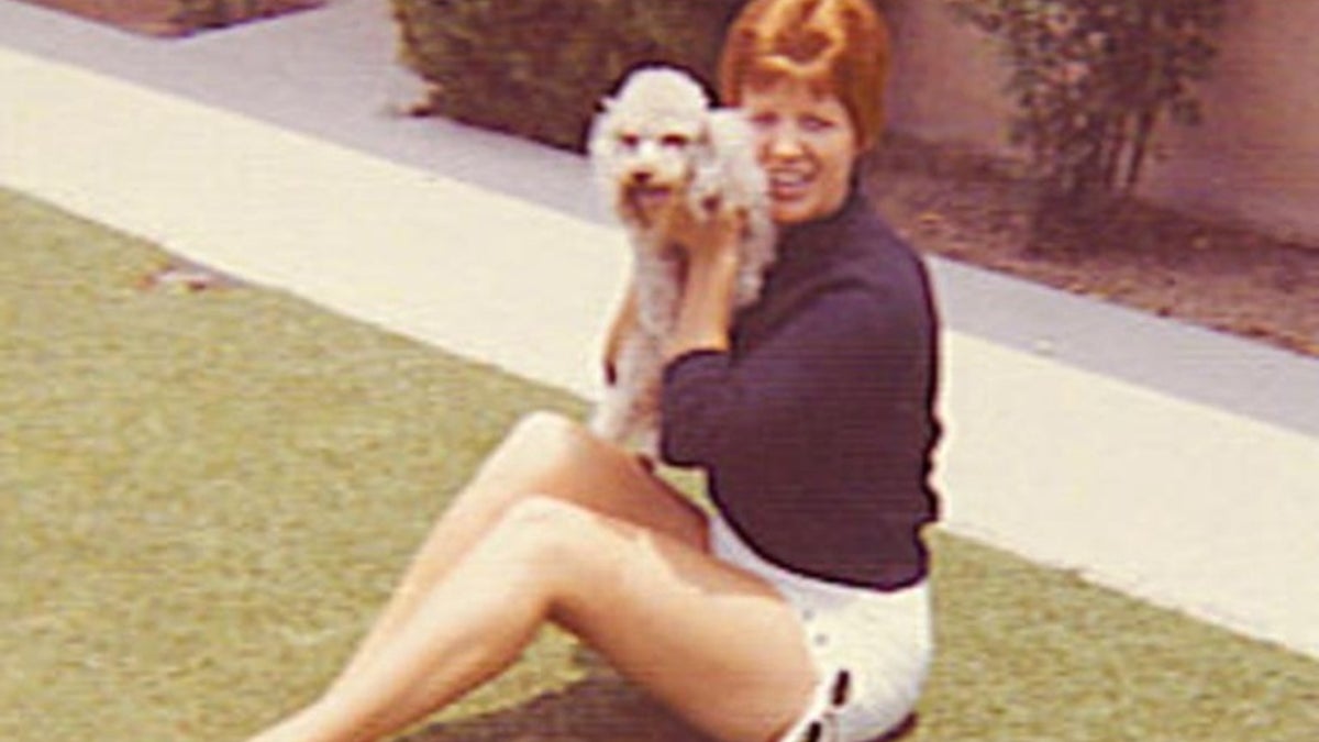 Photo shows Ruth MArie terry posing with dog