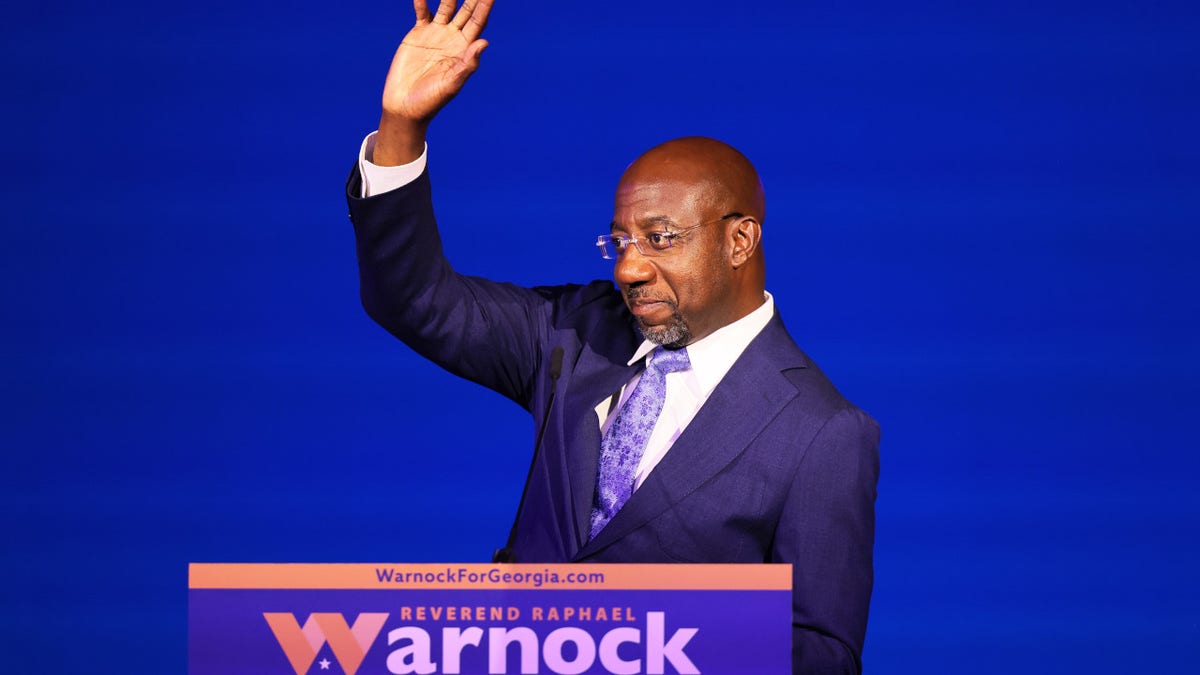 Senator Raphael Warnock waving to card