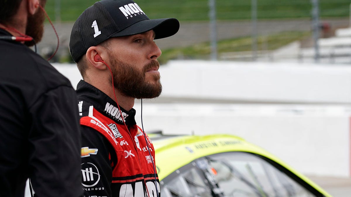 Ross Chastain watches cars in the pits