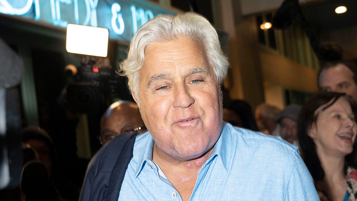 Jay Leno in a light blue button down returns to comedy club in Hermosa Beach after accident