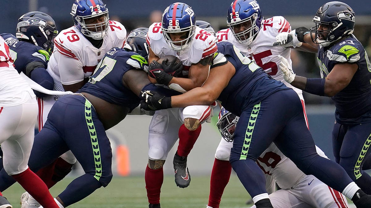 Saquon Barkley runs through tacklers