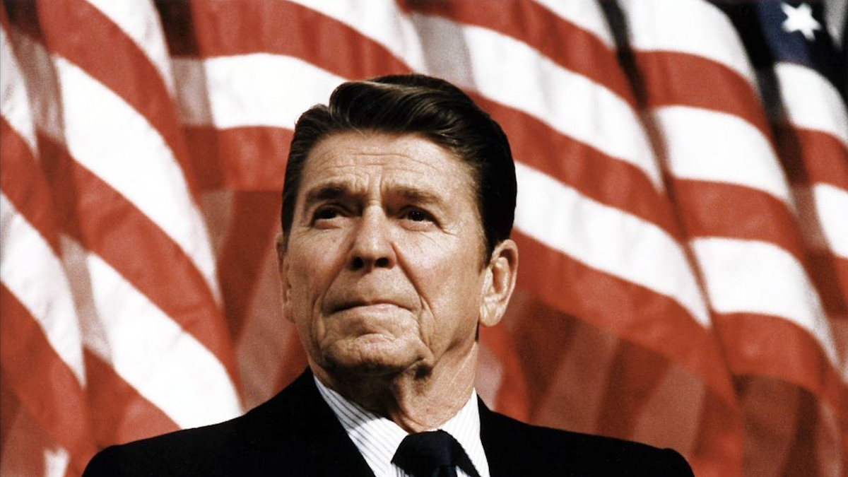 Ronald Reagan, with flag behind him