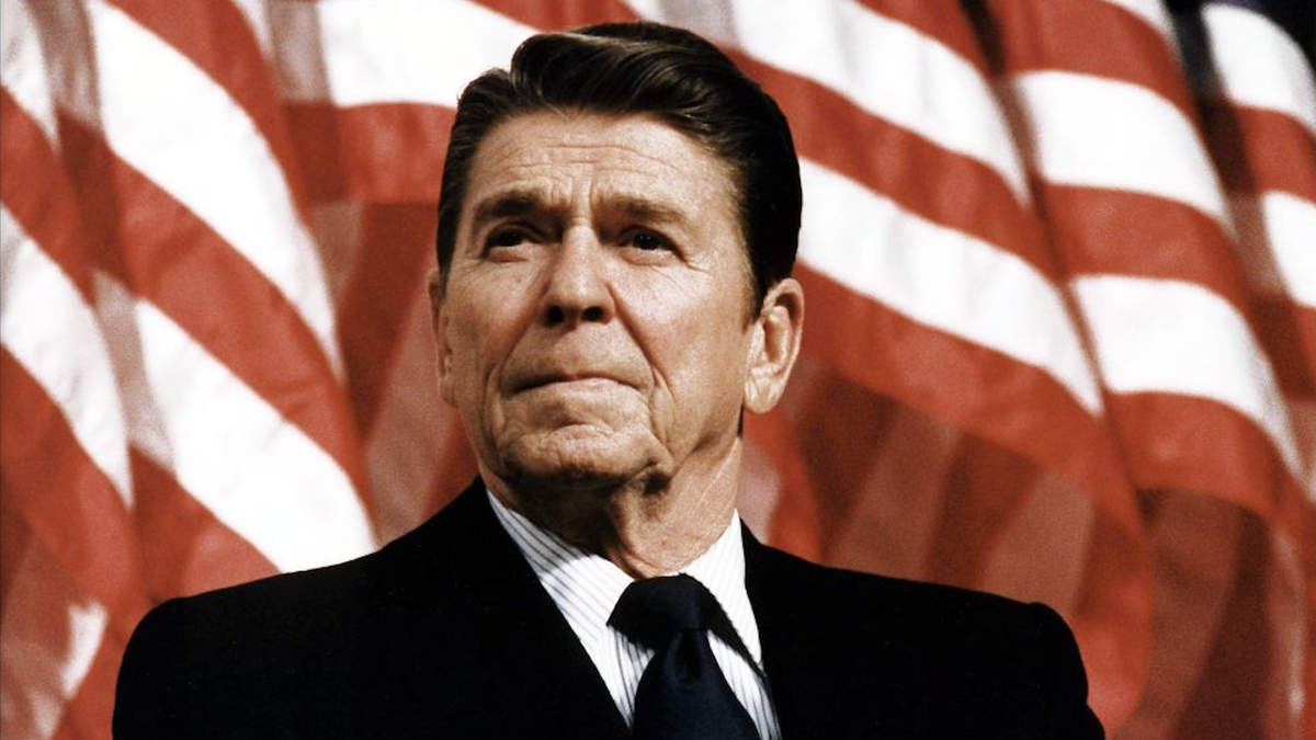 Ronald Reagan, with flag behind him