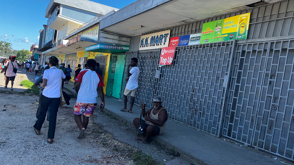 People gather outside stores in the Solomon Islands