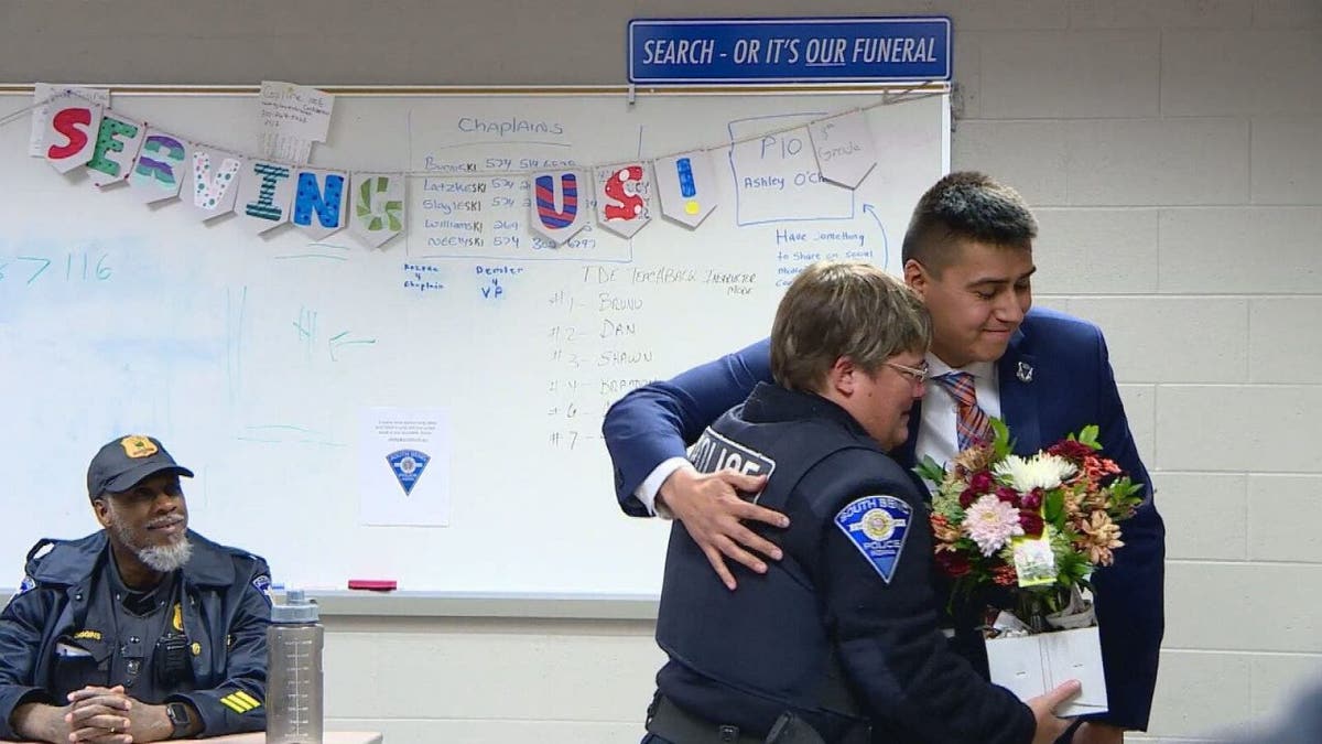 Roberto Theiss and Officer Anne Hayes hug
