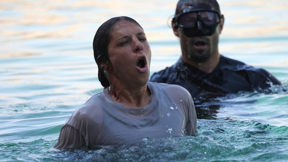 Carli Lloyd emerges from underwater on Special Forces show