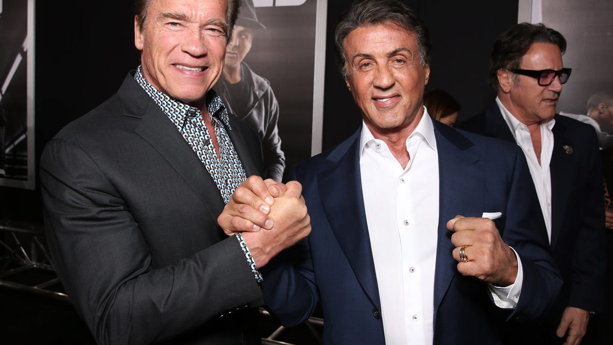 Sylvester Stallone and Arnold Schwarzenegger pose at 'Creed' premiere in Westwood in 2015