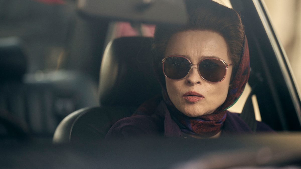 Helena Bonham Carter portrays Princess Margaret while driving with a red scarf and dark sunglasses