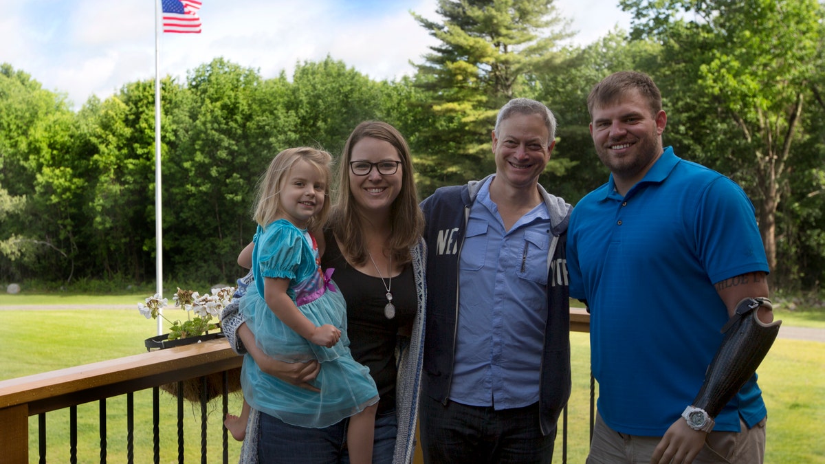 Gary Sinise and the family of Travis Mills