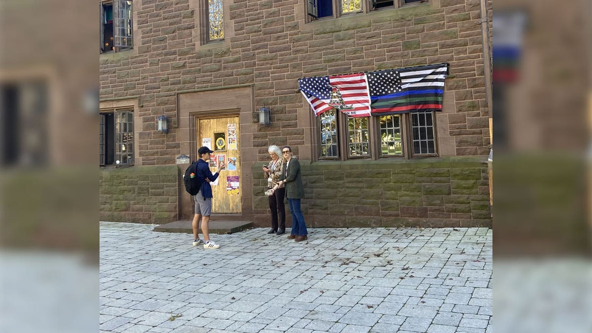 School administrators standing outside window