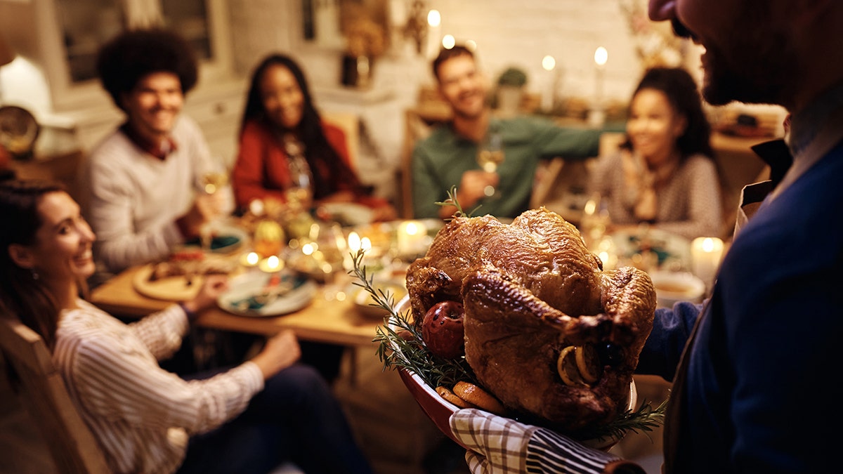 Man serving Thanksgiving turkey