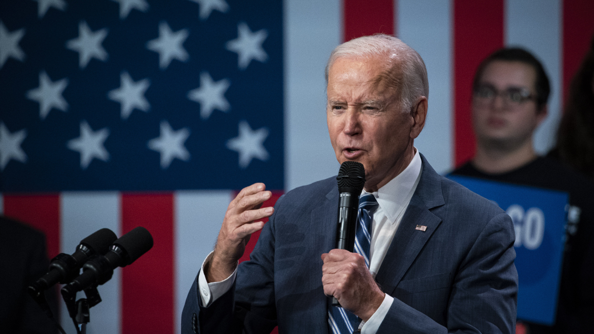 President Biden speaking in front of U.S. flag