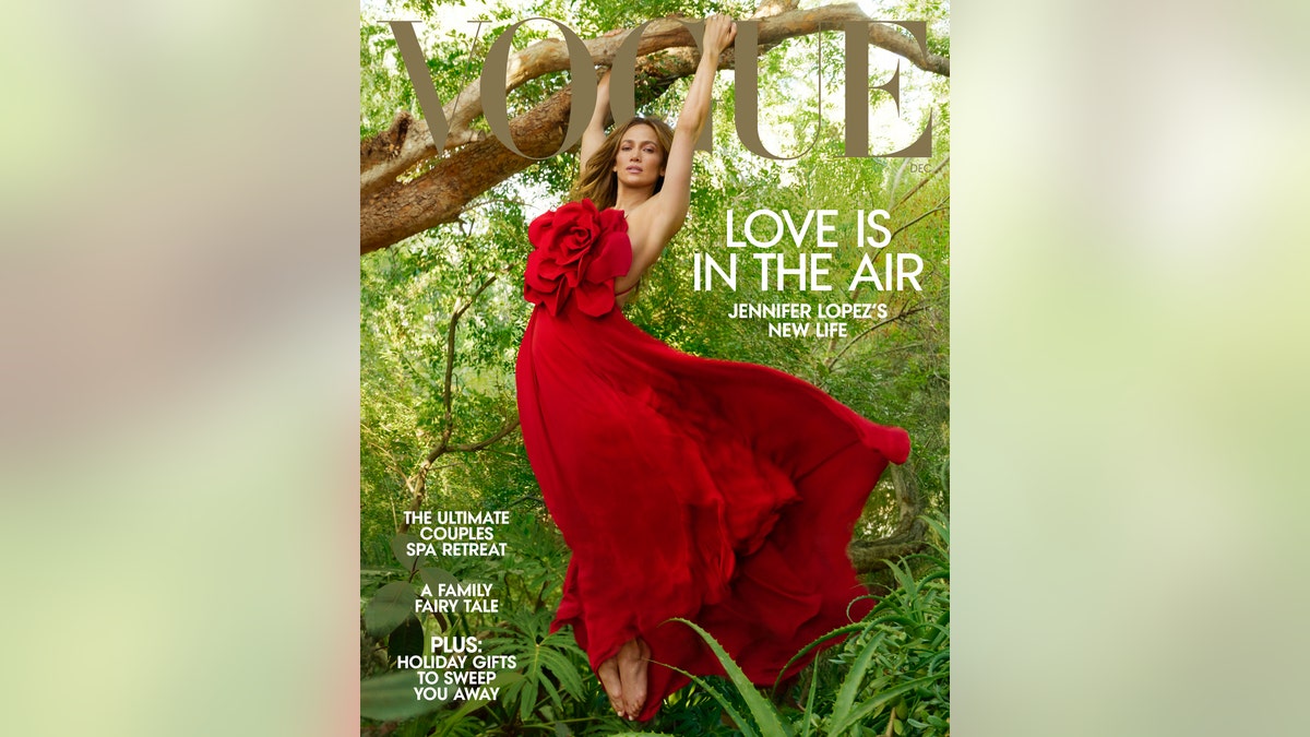 Jennifer Lopez hangs from a tree in a red dress for the cover of Vogue