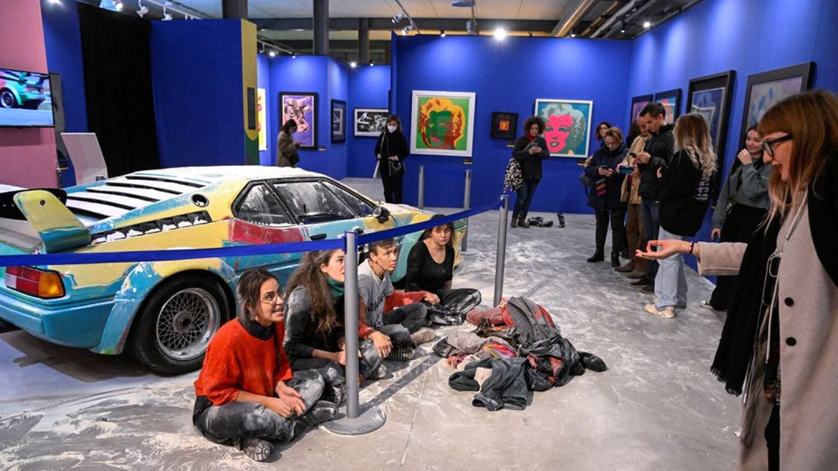 Protestors pose Andy Warhol Painted BMW