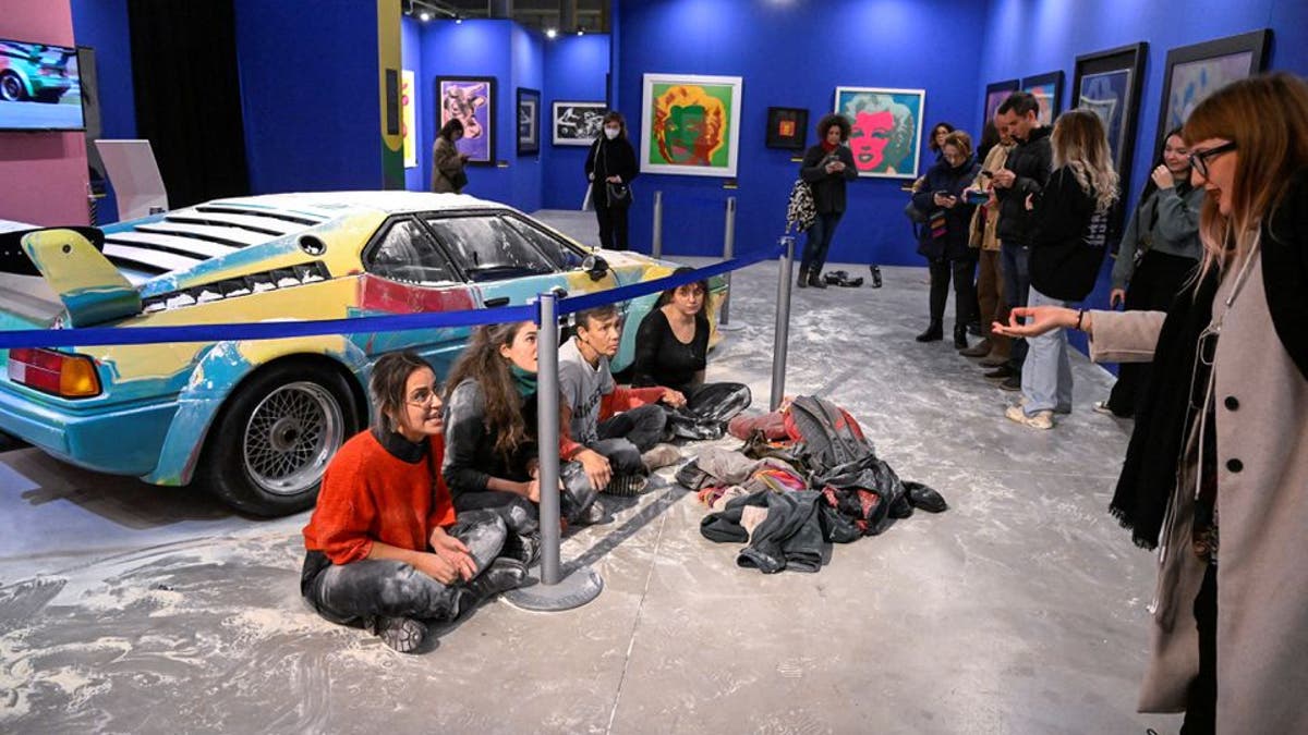 Protestors pose Andy Warhol Painted BMW