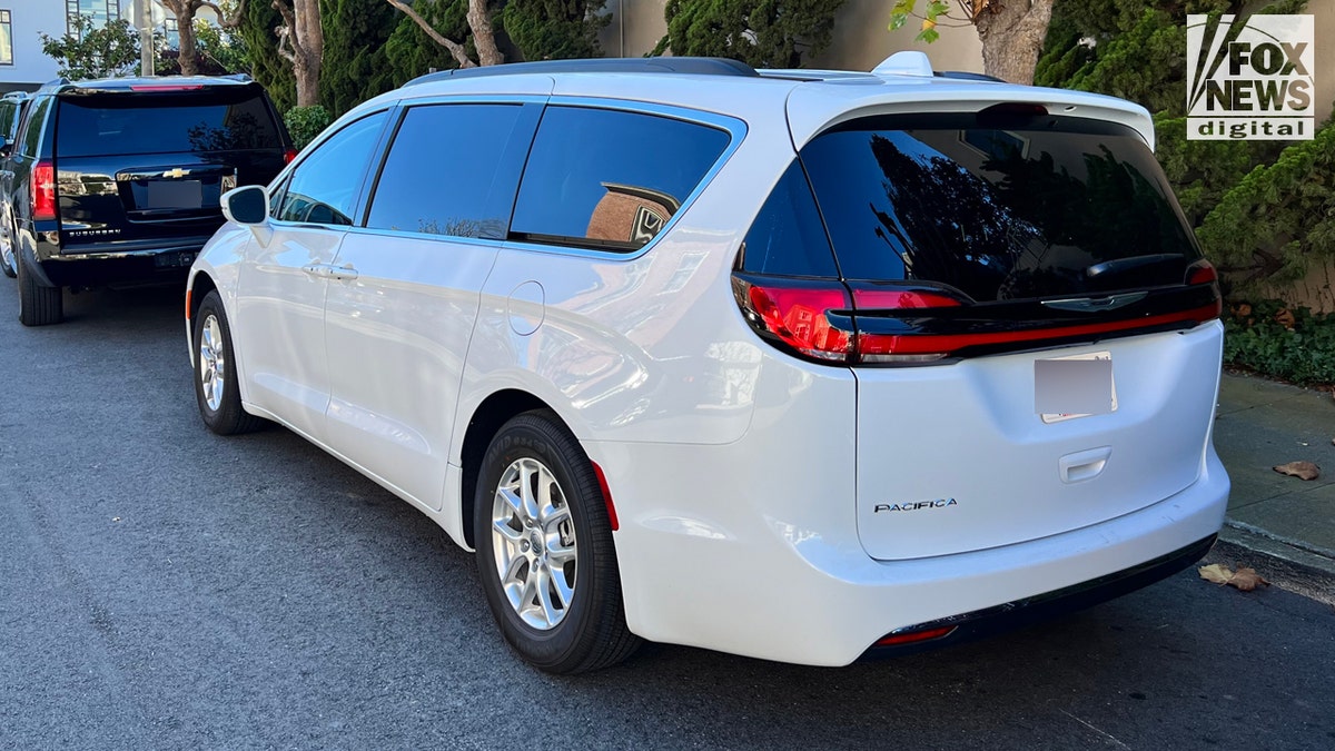 White Chrysler Pacifica van parked on side of street