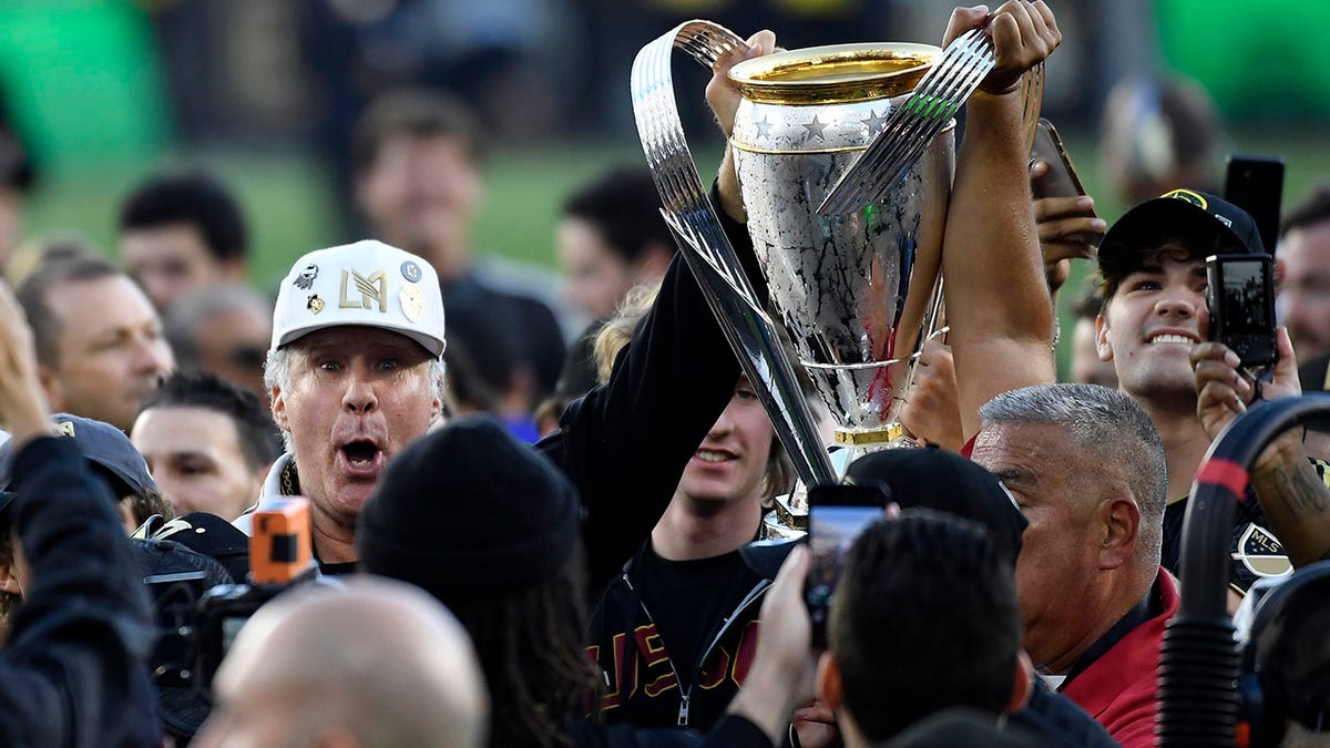 Will Ferrell holds the cup