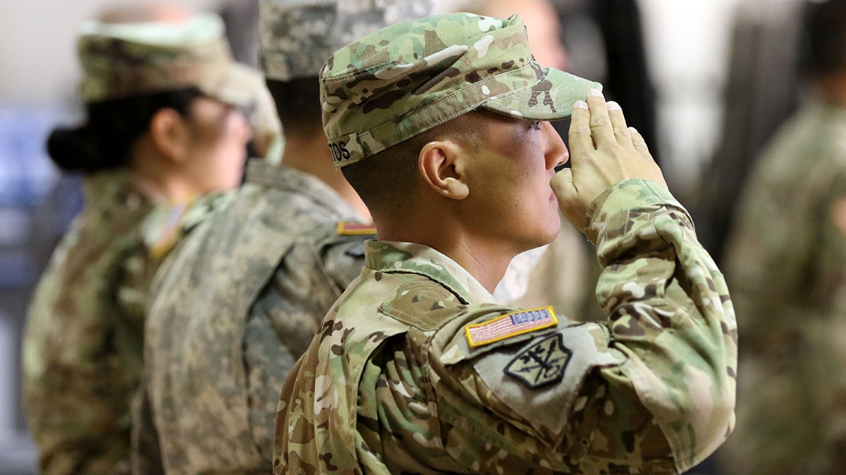 Army national guardsmen salute