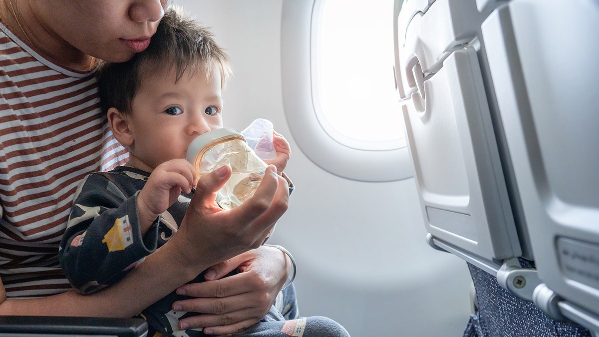 baby drinking bottle during flight