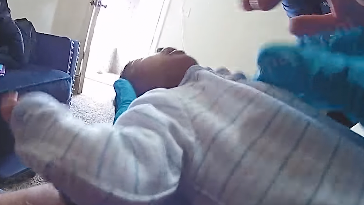 Baby receiving medical attention from officer