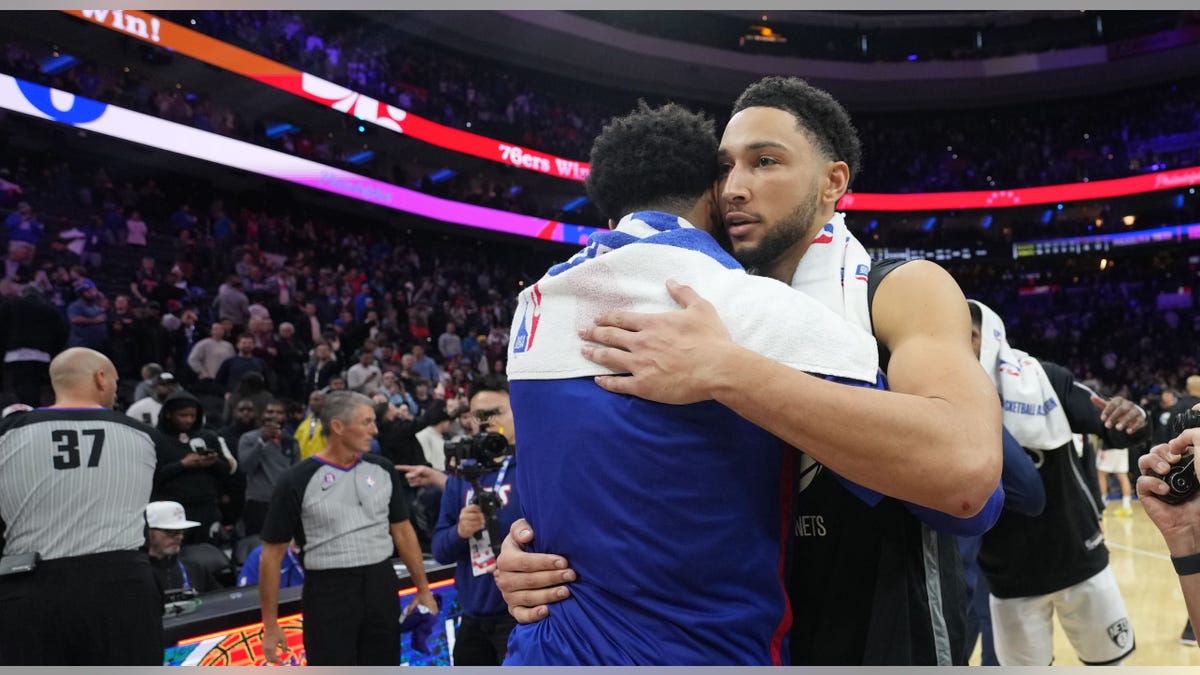Ben Simmons hugs Tobias Harris