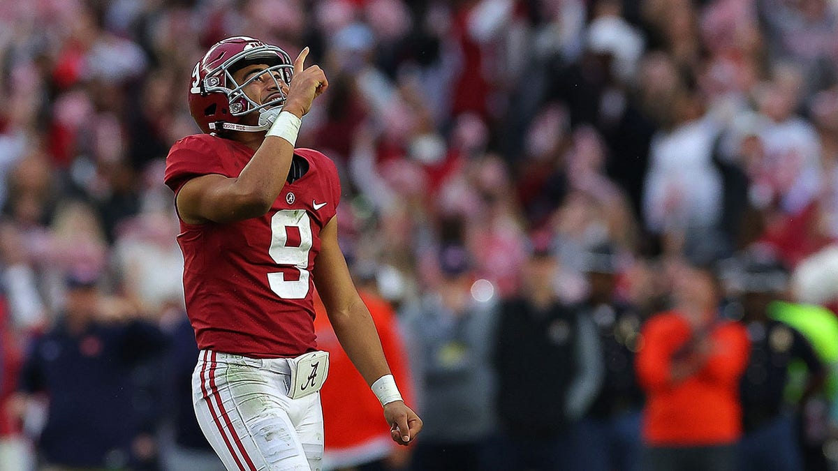 Bryce Young #9 of the Alabama Crimson Tide reacts after passing for a touchdown to Traeshon Holden #11 against the Auburn Tigers during the first half at Bryant-Denny Stadium on November 26, 2022 in Tuscaloosa, Alabama. 