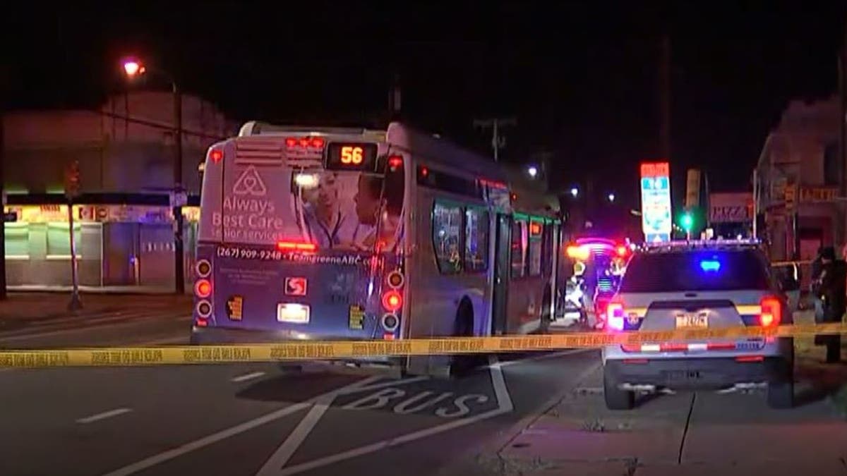 Philadelphia bus behind police tape at n ight