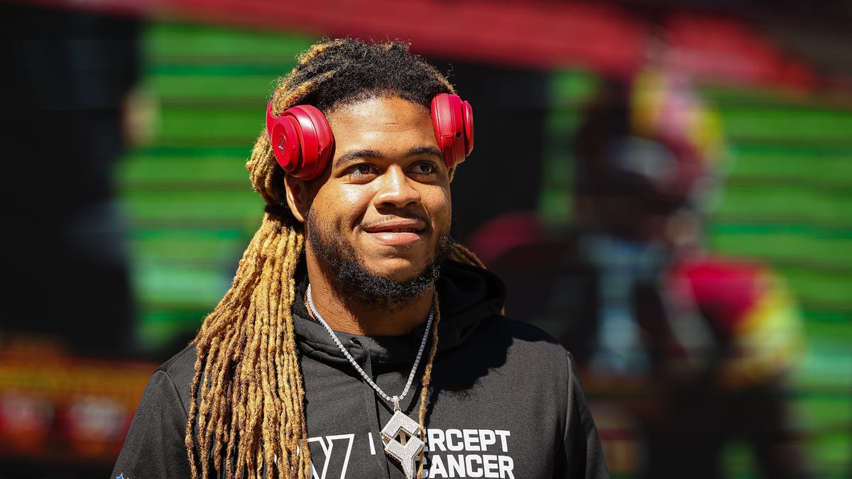 Chase Young smiles with headphones on