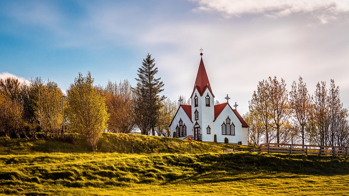 Beautiful white Scandinavian church in Iceland at sunrise