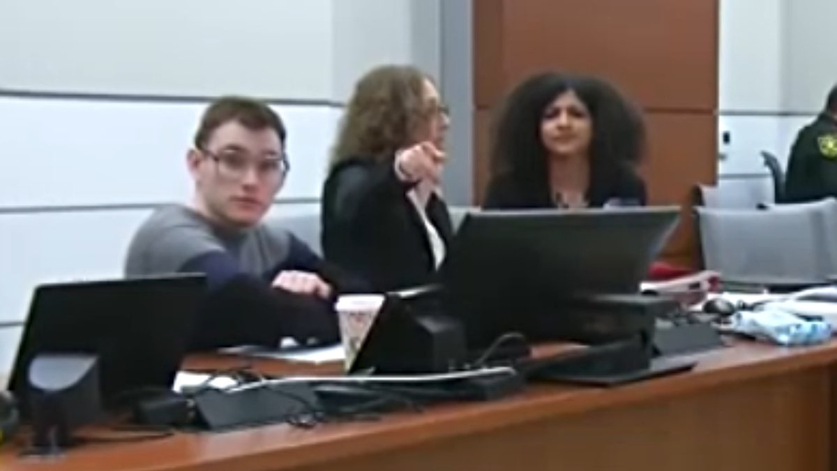 Tamara Curtis points at a courtroom camera