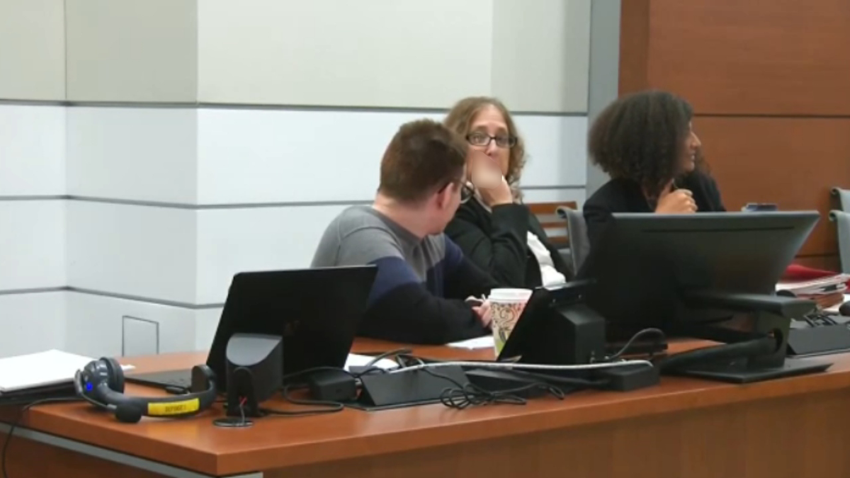 Tamara Curtis flips off a camera in a Broward County courtroom.