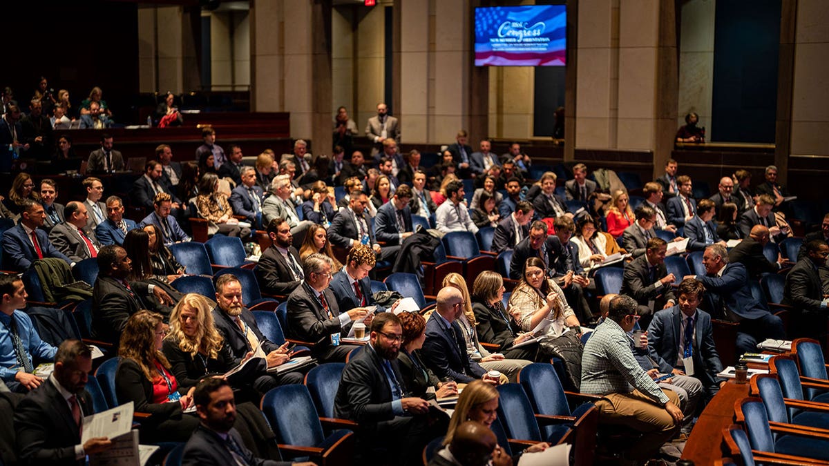 New members sit in an auditorium for orientation after the midterms