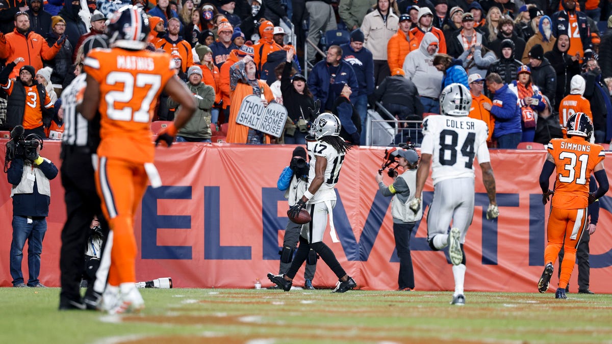 Davante Adams (17) of the Las Vegas Raiders scores a touchdown in overtime to beat the Denver Broncos at Empower Field at Mile High on Nov. 20, 2022, in Denver.