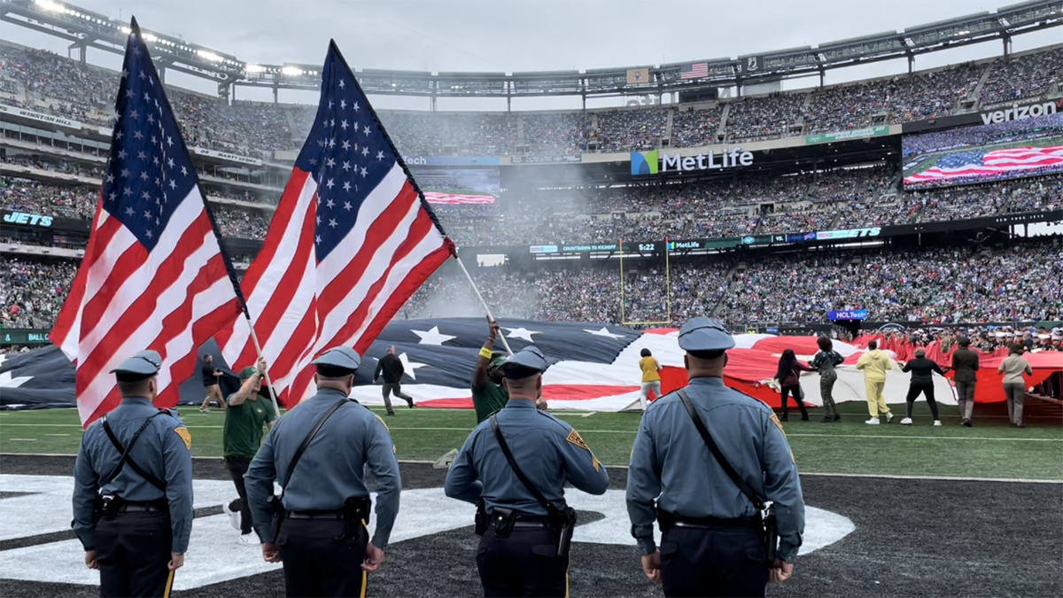 Service members from each branch welcome the New York Jets to the
