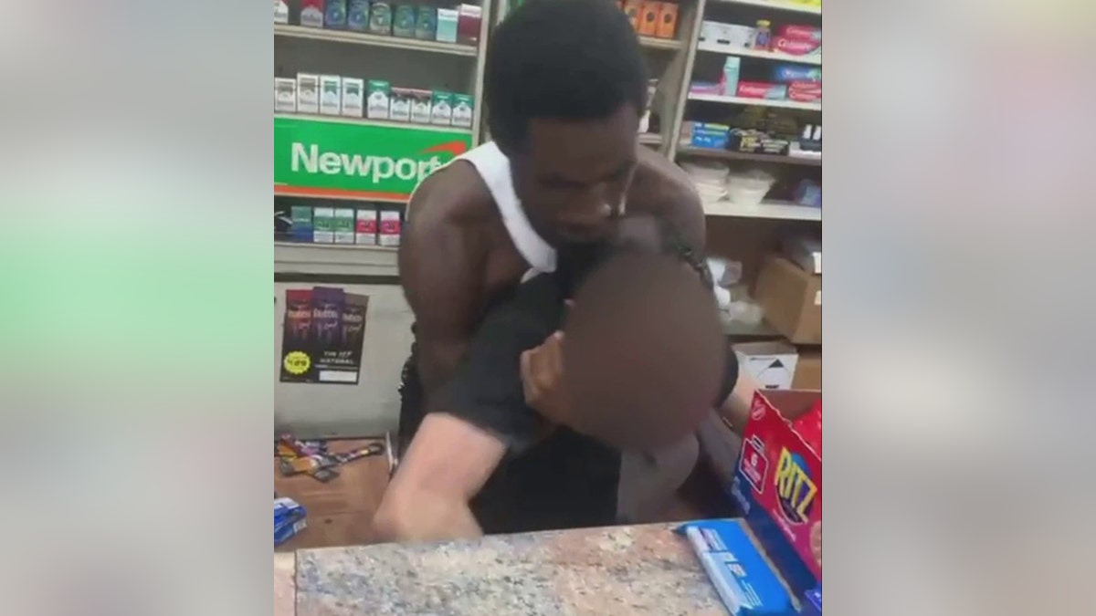 suspect holding cashier behind counter