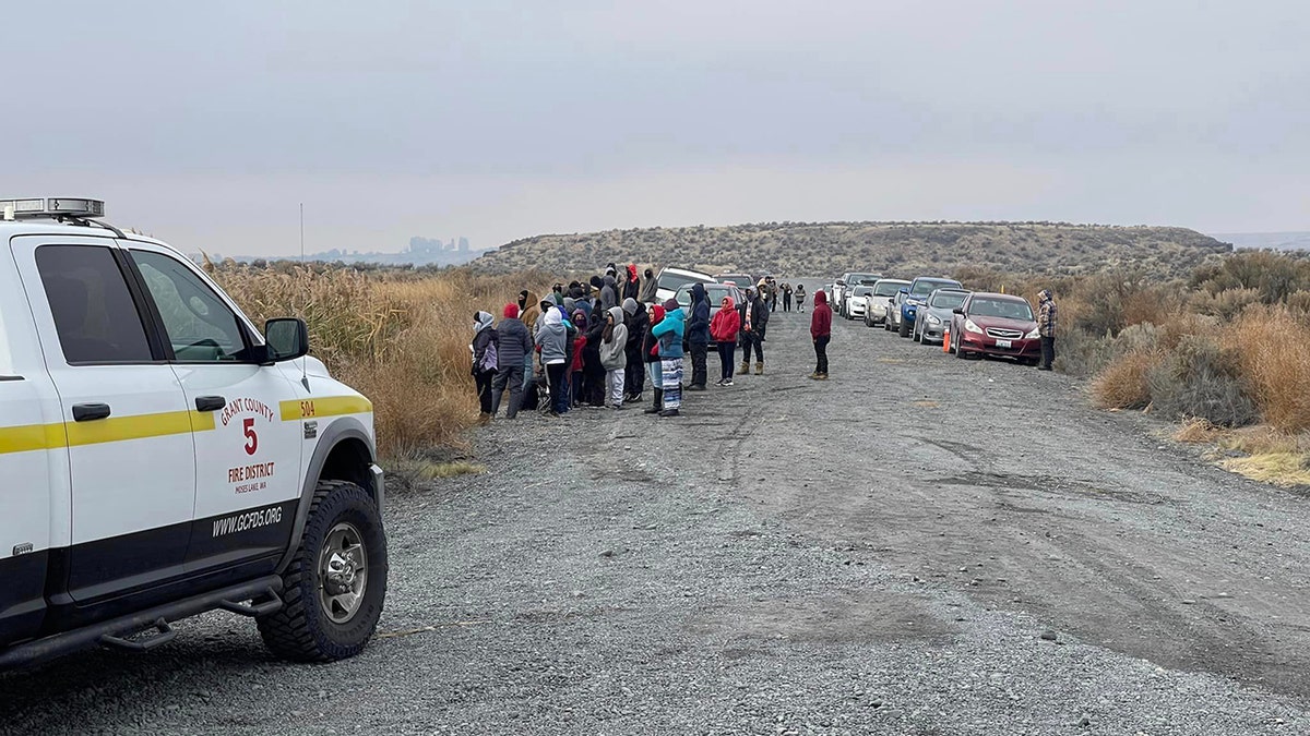 searchers gather near lake