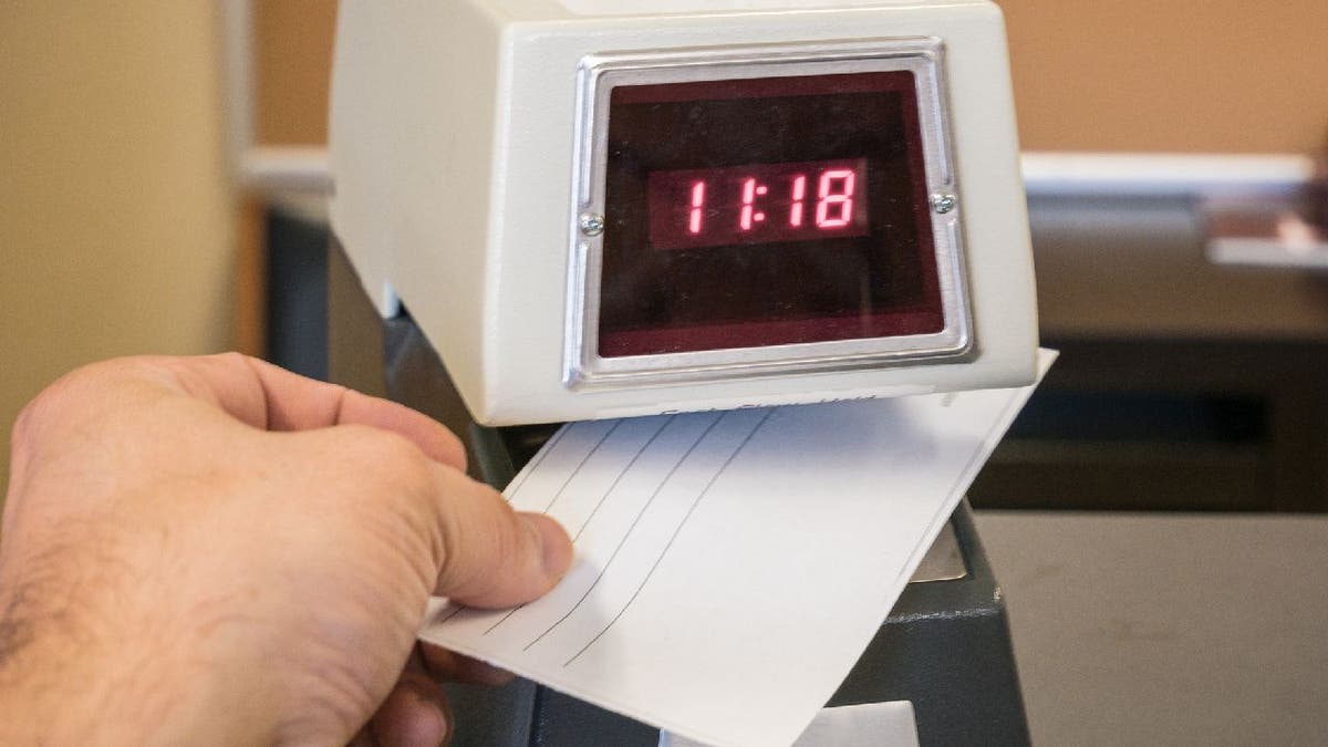 Close-up view of a punch time clock