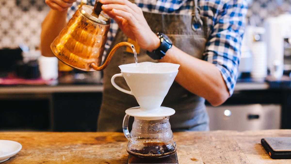 Person pours coffee into dripper