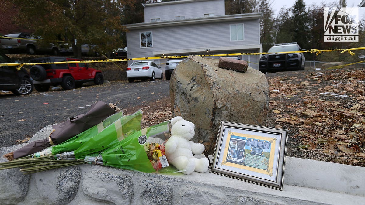 Memorial with stuffed bears and a photo in front of University of Idaho house
