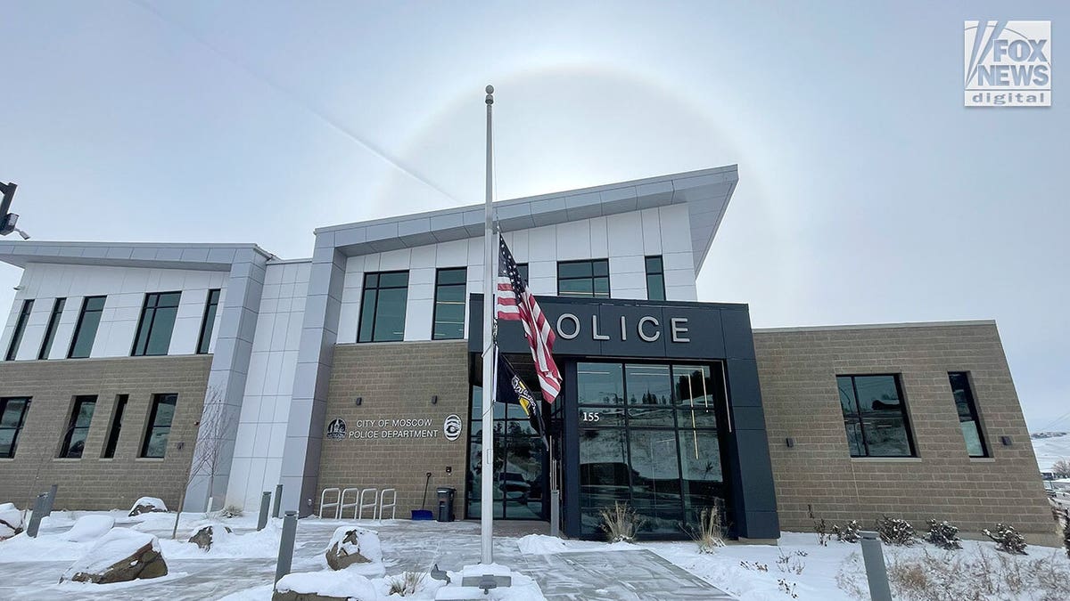 Flag at half staff outside of Moscow, Idaho police station on a sunny day