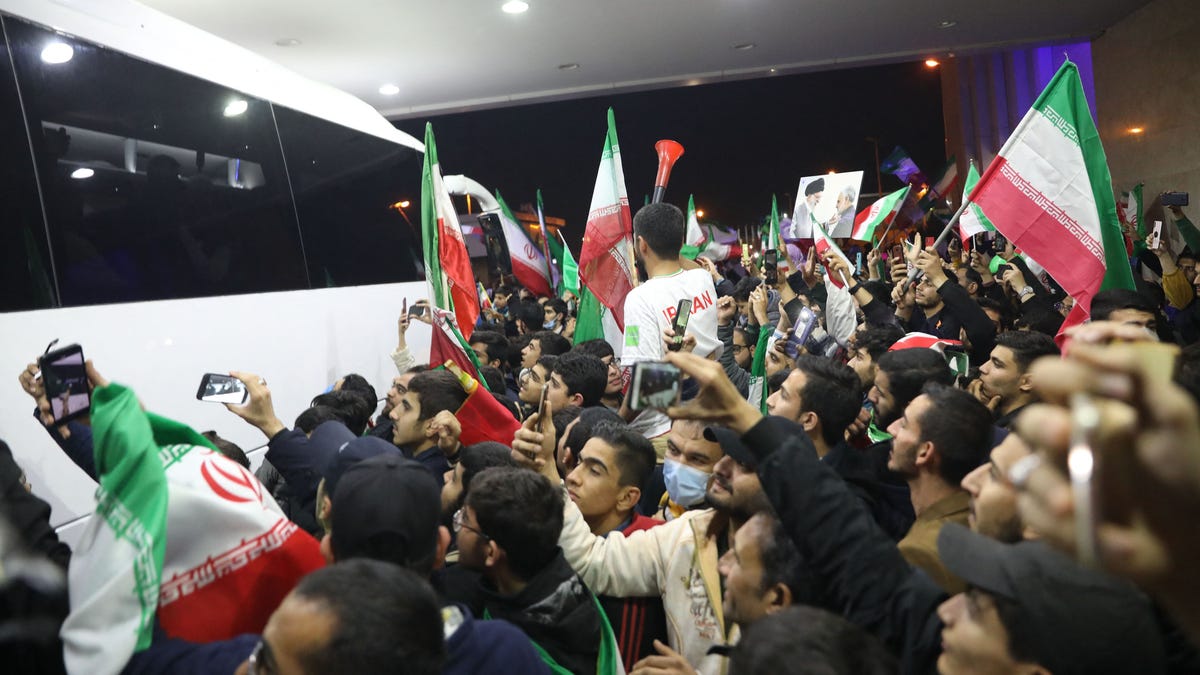 Iran fans gather around team bus